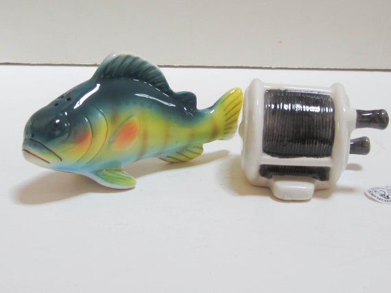 A Vintage Pair of Cèramic Bass Fish and a Fishing Reel Salt and