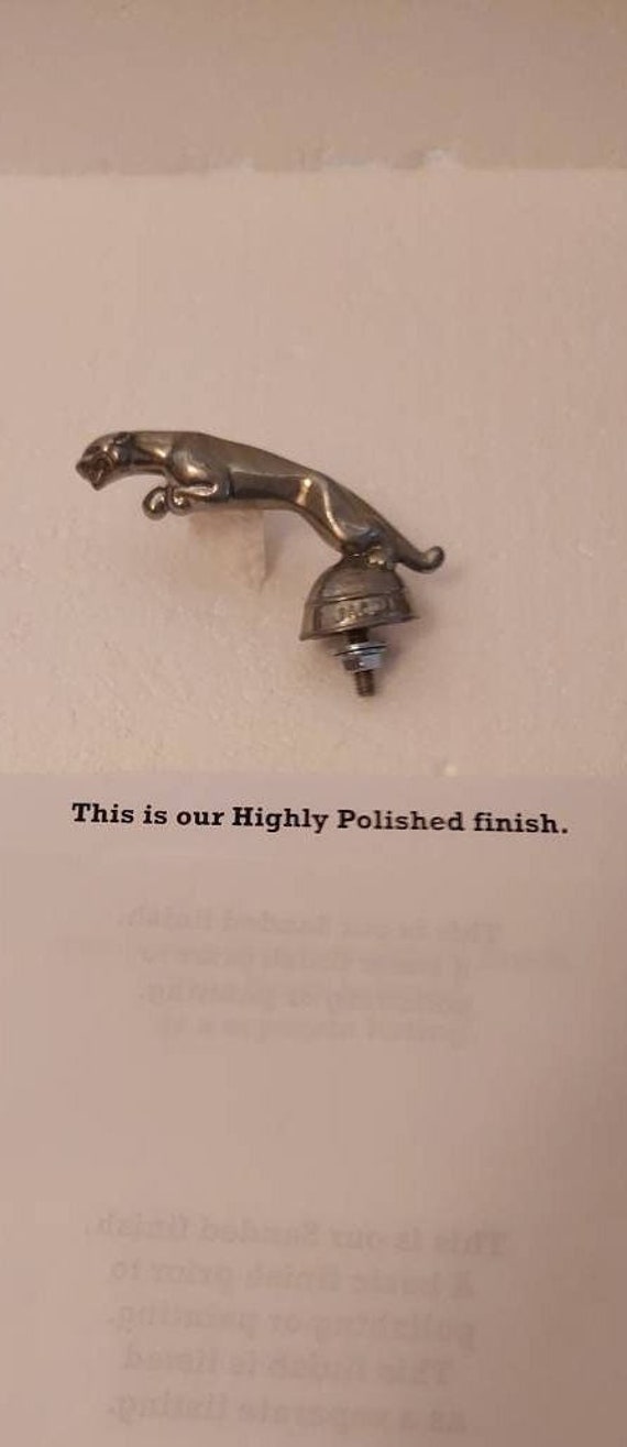 Topper of a 1950's Jaguar auto car hood ornament mascot by Hoffman in Aluminum metal + in assorted finishes - made in the USA