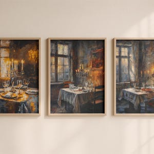 May include: A set of three vertical wall art prints in light wood frames, each depicting an oil painting of a dining room scene with a table set for a meal, a candelabra with lit candles, and a window with warm golden light filtering through.