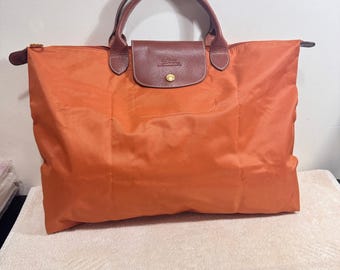 Borsa da viaggio grande Longchamp da donna, arancione e marrone, anni 2000.
