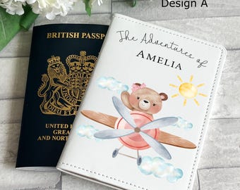 May include: White passport holder with a cartoon bear flying a plane. The text "The Adventures of Amelia" is printed on the front.
