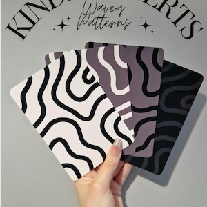 May include: Kindle inserts with wavy patterns in black, white, and grey. The inserts are matte cardstock and sold individually. The text "Kindle Inserts" and "Wavy Patterns" are arched at the top.