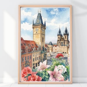 May include: Watercolor print of a European city scene featuring a tall clock tower and ornate buildings. The artwork is framed and includes colorful flowers in the foreground, with a blue sky and clouds in the background.