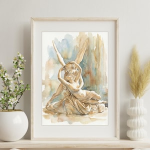 May include: Watercolour painting of a sculpture showing two figures embracing, set against a backdrop of soft blues and browns. The artwork is framed in a light wood frame and displayed on a shelf with decorative elements.