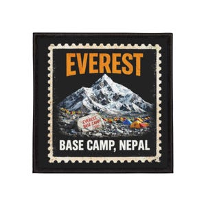 May include: Black square patch with a postage stamp design featuring Mount Everest. The patch has the word "EVEREST" in orange, and "BASE CAMP, NEPAL" in white. A small sign reads "EVEREST BASE CAMP 5364M".