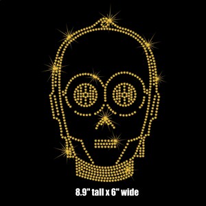 May include: Gold rhinestone design of a robot head, 8.9 inches tall and 6 inches wide.