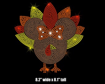 May include: A brown turkey with a red wattle and yellow, orange, and red feathers. The turkey is made of rhinestones and measures 8.2 inches wide by 8.1 inches tall.