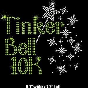 May include: Green and white rhinestone design featuring the text "Tinker Bell 10K" with a wand and stars. The design is 8.1 inches wide and 7.2 inches tall.