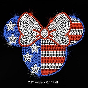 May include: A red, white, and blue rhinestone design of a bow in the shape of Mickey Mouse ears. The design is 7.7 inches wide and 6.1 inches tall.