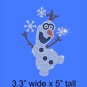 May include: A sparkly, white, blue, and black rhinestone design of Olaf, the snowman from the movie Frozen. The design is 3.3 inches wide and 5 inches tall.