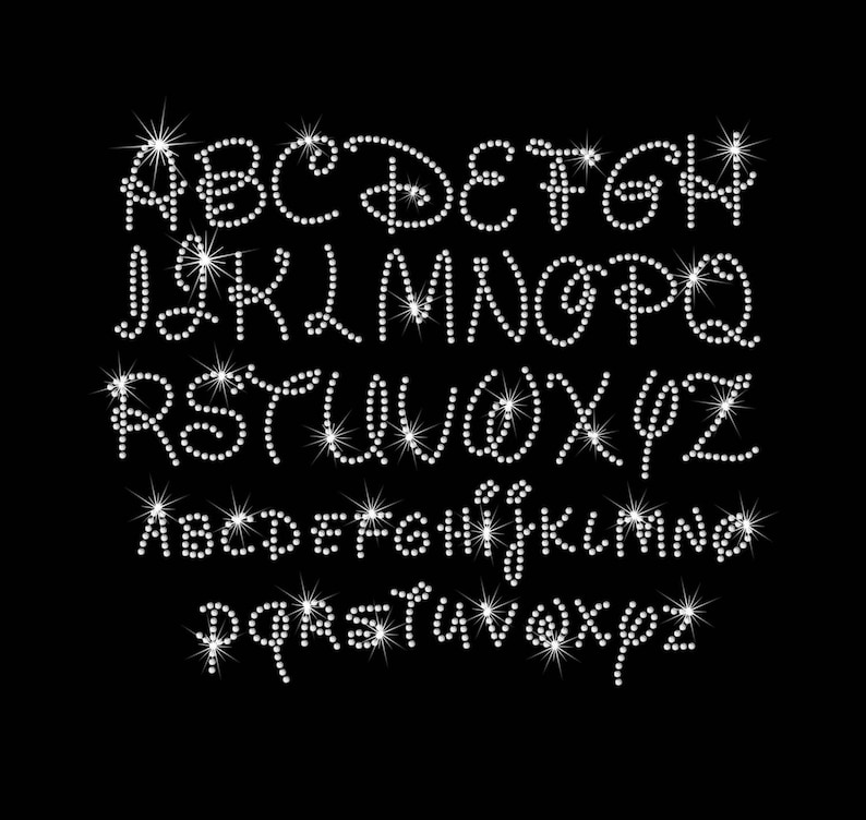 May include: A set of uppercase and lowercase letters made of white rhinestones. The letters are arranged in two rows, with the uppercase letters on top and the lowercase letters on the bottom.