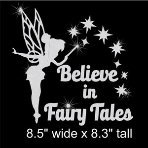 May include: A silver glitter fairy with wings and a wand, surrounded by stars, with the text "Believe in Fairy Tales" and the dimensions 8.5 inches wide by 8.3 inches tall.