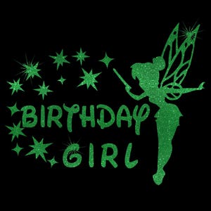 May include: Green glitter design featuring a fairy with wings and a wand, surrounded by stars. The text "BIRTHDAY GIRL" is below the fairy.