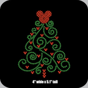 May include: A green and red rhinestone Christmas tree design with a heart-shaped ornament at the top. The tree is 4 inches wide and 5.1 inches tall.