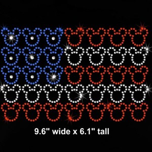 May include: A red, white, and blue American flag design made of rhinestones. The flag is made up of Mickey Mouse heads. The flag is 9.6 inches wide and 6.1 inches tall.
