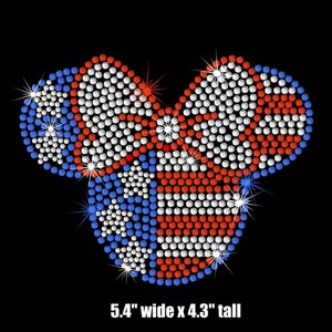 May include: A red, white, and blue rhinestone design in the shape of a heart. The design is 5.4 inches wide and 4.3 inches tall.