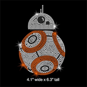 May include: A white and orange robot design made of rhinestones, measuring 4.1 inches wide by 6.3 inches tall.