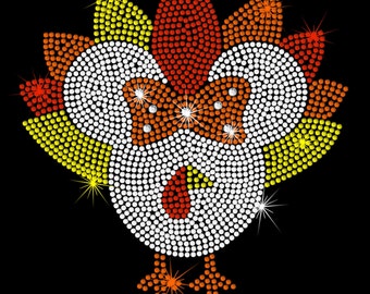 May include: A white turkey with a red beak and orange feet, surrounded by a yellow, orange, and red feather design. The turkey is made of rhinestones and measures 8.2 inches wide by 8.1 inches tall.