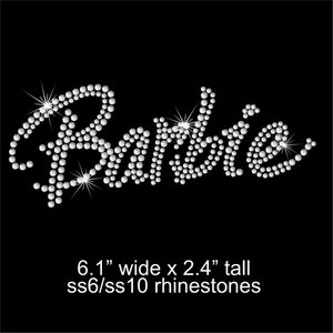 May include: A rhinestone transfer featuring the word Barbie in a cursive script font. The design is composed of clear, sparkling crystals on a black background. Text below reads 6.1 inches wide by 2.4 inches tall, using ss6 and ss10 rhinestones.