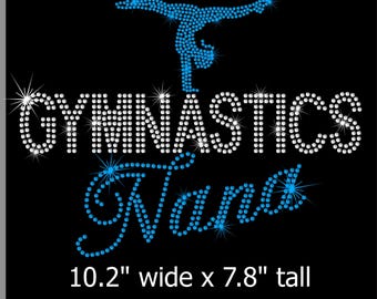 May include: Black graphic design with the words "GYMNASTICS Nana" in white and blue rhinestones. A gymnast in blue rhinestones is at the top. The design is 10.2" wide and 7.8" tall.