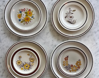 Vintage 1970's mismatched graphic floral salads with coordinating dinners. Sold separately.