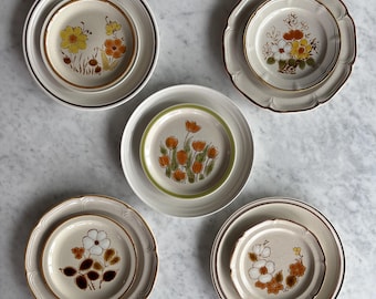Vintage 1970's mismatched painterly floral salads with coordinating dinners made in Japan. Sold separately.