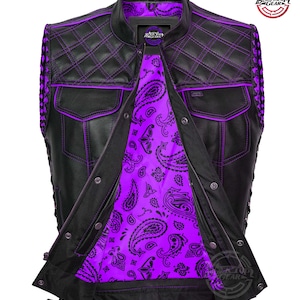 May include: Black leather vest with purple stitching and a paisley purple lining. The vest features a quilted pattern on the shoulders and upper back, two front pockets, and a zipper closure. The vest has a round collar and a Black Top Gear logo.