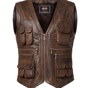 May include: A brown leather vest with multiple pockets and a zip-up front. The vest has a V-neck design and a label at the neck. The vest has a rugged, worn appearance.
