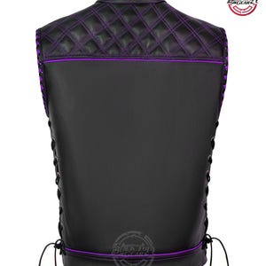 May include: Black leather vest with purple stitching and accents. The back features a quilted pattern on the upper portion and a lace-up design on the sides. The vest has a collar and a logo on the back.
