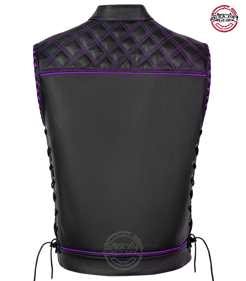 May include: Black leather vest with purple stitching and accents. The back features a quilted pattern on the upper portion and a lace-up design on the sides. The vest has a collar and a logo on the back.
