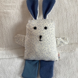 May include: A set of three ceramic mugs with a speckled, cream-colored glaze. Each mug features a different hand-painted floral design in shades of blue, green, and yellow. The mugs have a simple, rounded shape and a comfortable handle.