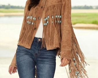 May include: Brown suede jacket with fringe detailing and turquoise-colored bead accents. The jacket has a button-up front and a classic collar. The fringe is long and hangs from the sleeves and chest.