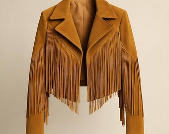May include: Mustard-colored suede jacket with fringe detailing. The jacket features a classic collar, long sleeves, and fringe along the front, sleeves, and back. A stylish outerwear piece.