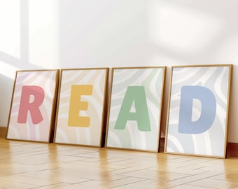 May include: Four rectangular framed prints arranged in a row, each featuring a single large letter in a pastel colour against a wavy, light-coloured background. The letters spell out the word READ in pink, yellow, green, and blue respectively.