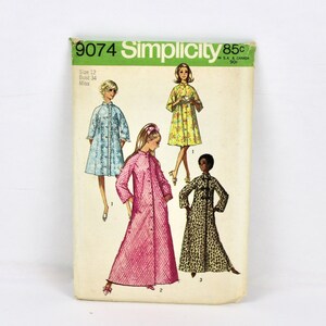 May include: Simplicity sewing pattern number 9074 for a long robe. The pattern shows four different styles of robes in blue, pink, yellow, and brown and black print.