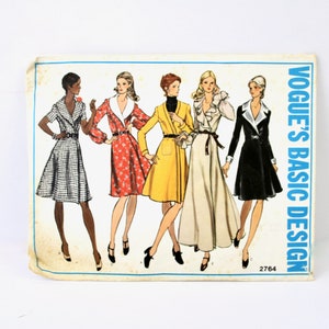 May include: Vintage Vogue's Basic Design sewing pattern, number 2764, featuring five women wearing different styles of dresses. The pattern includes a black and white gingham dress, a red floral dress, a yellow wrap dress, a beige wrap dress, and a black dress with a white collar.