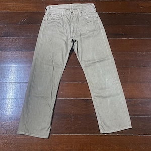 May include: A pair of light olive-green denim jeans. The jeans have a classic five-pocket design, a button and zipper closure, and a straight leg fit. The fabric appears worn and faded.