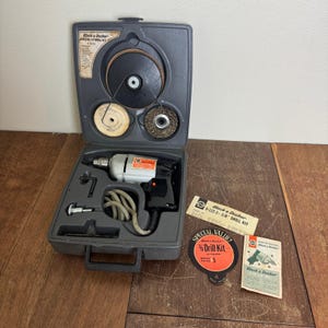 May include: A set of three ceramic mugs with a speckled, matte finish. The mugs are in shades of cream, light gray, and dark gray. Each mug has a simple, minimalist design and a rounded handle.