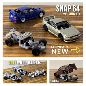 May include: A close-up of a small, gray, plastic chassis for a toy car. The chassis has a motor, wheels, and a steering mechanism. The text "Drift with precision." is visible in the image. The text "SNAP 64 VERSION 2.0" is also visible in the image.