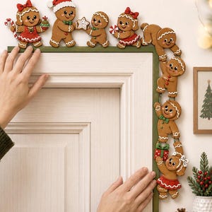 May include: A decorative wooden door frame topper featuring a series of brown gingerbread figures. The figures are painted with white icing details, red clothing, and green accents, holding holiday items like candy canes, stars, and gifts.