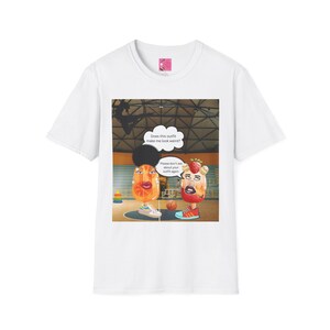 May include: A white t-shirt featuring a graphic of two anthropomorphic fruit characters on a basketball court. One character is orange-themed, the other strawberry-themed. Speech bubbles contain the text: Does this outfit make me look weird? and Please don't ask about your outfit again.