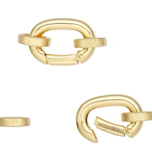 May include: Two gold-toned metal clasps, one open and one closed, with a smaller gold-toned metal ring.