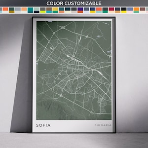 May include: A framed map print of Sofia, Bulgaria, in a muted green color scheme. The city's road network is depicted in white against the green background. The text "SOFIA" and "BULGARIA" are displayed at the bottom of the print.