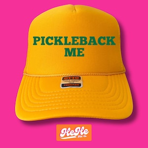 May include: A yellow trucker hat with a green embroidered design that says "Pickleback Me". The hat has a black label that says "Otto World Famous Foam Front 6-Panel Trucker".
