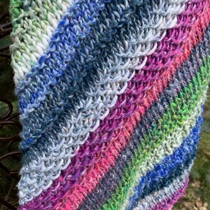 May include: A colourful knitted scarf with stripes of blue, green, pink and white.