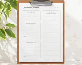 May include: A daily focus planner on a clipboard with sections for today's major goal, must-do tasks, could-do tasks, and more ideas.