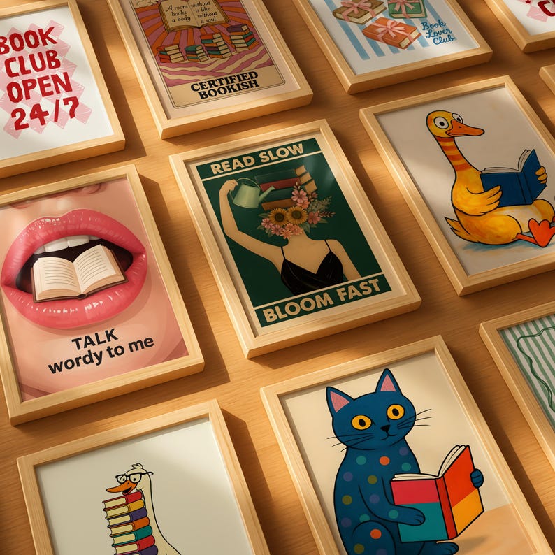 May include: A collection of framed art prints with a book-themed aesthetic. The prints feature various illustrations and text, including a duck reading a book, a cat reading, and the phrases "Book Club Open 24/7" and "Talk wordy to me."