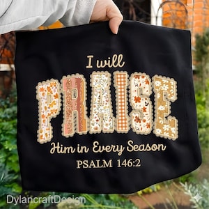 May include: Black tote bag with the words "I will PRAISE Him in Every Season" in a decorative font. The word "PRAISE" is filled with floral and patterned designs. Psalm 146:2 is printed below the text.