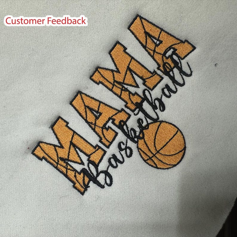 May include: A white sweatshirt with black embroidery that reads "Mama Basketball" with a basketball graphic in orange and black.