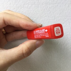 May include: Red plastic stamp with a cake design and the text "スタンプのがあいてから、●バーでとするときが来ます。フリクションスタンプは消せるスタンプです。・名など消えてはいけないものには使用しないでください。JAPAN" on the side.